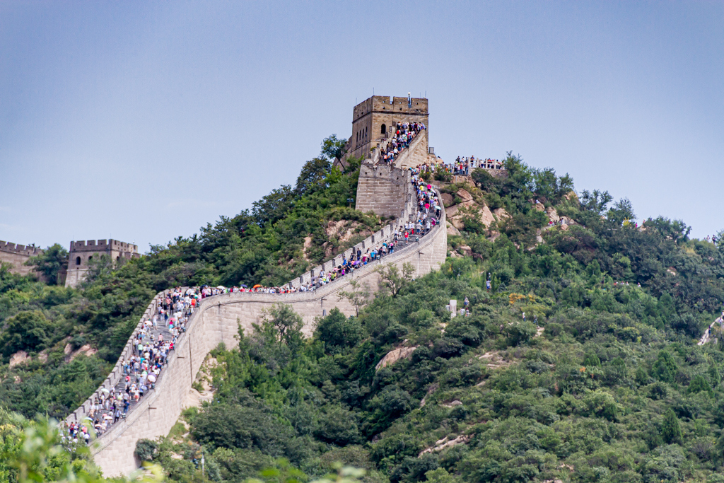 Great Wall of China with tourists walking on top.